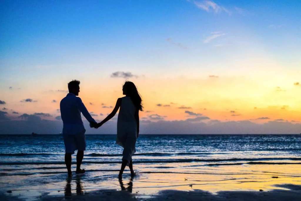 couple holding hands on the beach