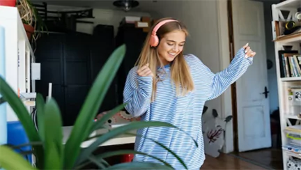 a confident young woman dancing to music