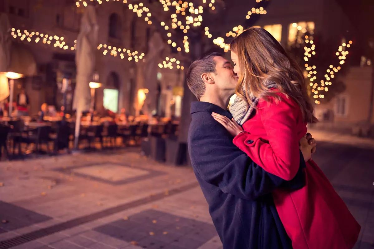 Young couple kissing at night