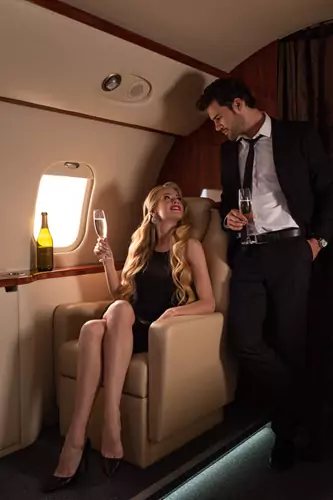 Millionaire couple on a private jet